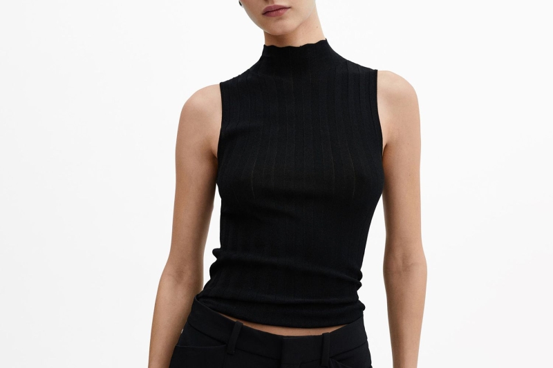 Look of the Day for April 16, 2024 features Jennifer Aniston in an all-black look that includes black trousers and a black turtleneck tank top that’s perfect for the springtime. Shop similar turtlenecks from Spanx, Free People, and Madewell.