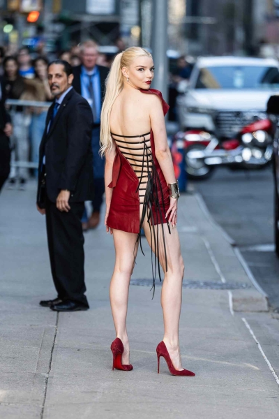 Anya Taylor-Joy wore a red Mugler dress with a lace-up back detail in New York City. See the full look, here.
