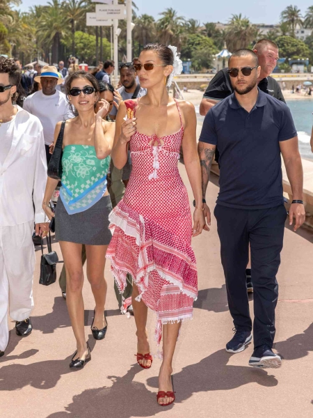 Bella Hadid put a glamorous twist on dayttime attire with her slinky white dress that featured a draped asymmetric back cutout at Cannes Film Festival.