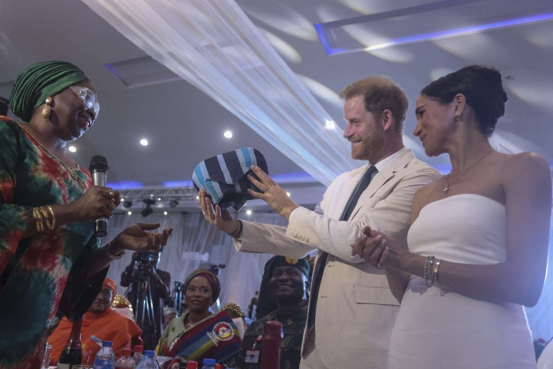 Meghan Markle and Prince Harry wore coordinating white linen looks to a special reception in Nigeria on May 11.