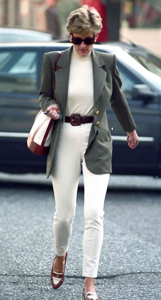 Meghan Markle wore an olive jacket over an all-white outfit in Los Angeles, recreating one of Princess Diana's go-to style moves. See the look, here.