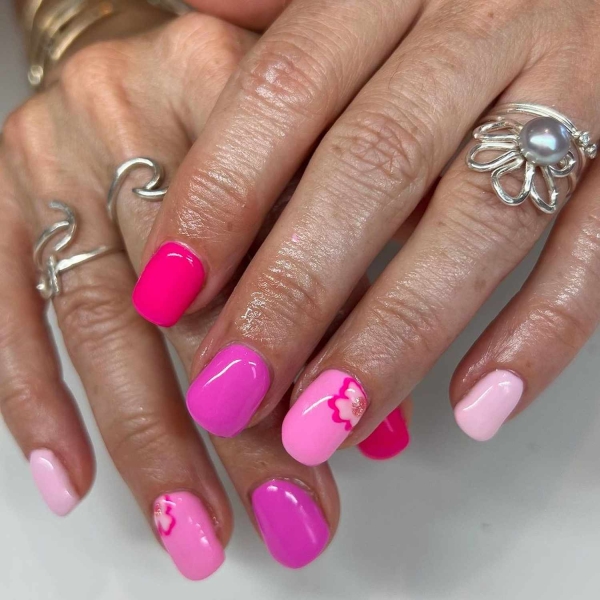 Short nails just make more sense for summer. From graphic designs to cool embellishments, find over a dozen short summer nail ideas for the months ahead here.