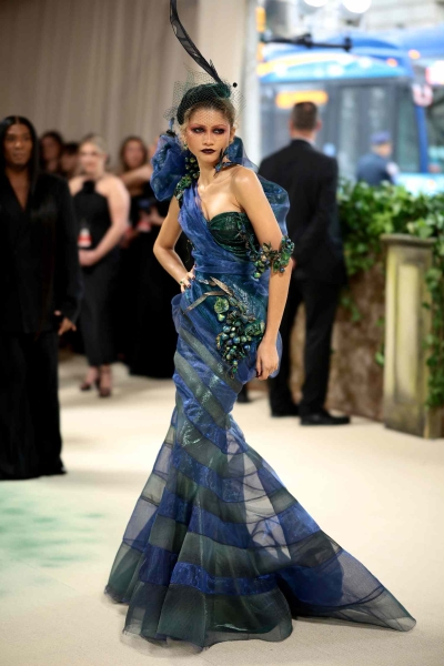 Zendaya, a 2024 Met Gala co-chair, arrived on the red carpet wearing an over-the-top blue and green Maison Margiela Couture gown. See her look from every angle here.