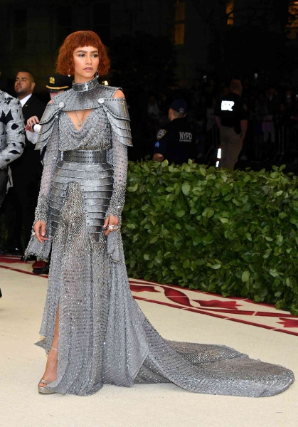 Zendaya, a 2024 Met Gala co-chair, arrived on the red carpet wearing an over-the-top blue and green Maison Margiela Couture gown. See her look from every angle here.