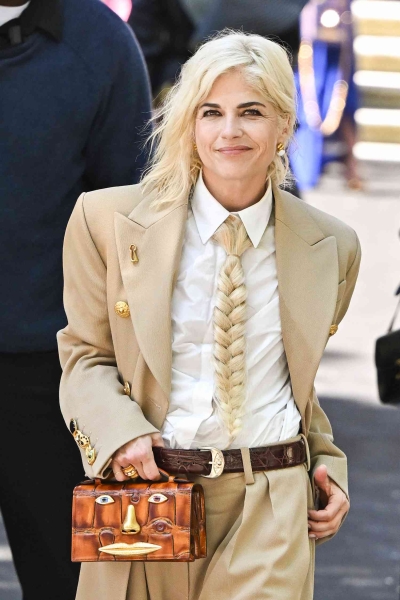 Actress Selma Blair wore a blonde, braided ponytail in lieu of a necktie at the Schiaparelli haute couture show in Paris. See her full look, here.