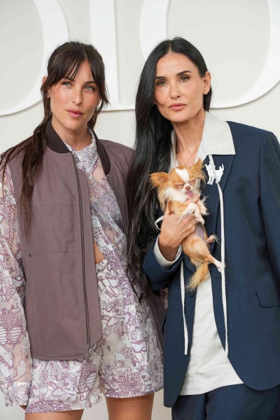 Demi Moore, her dog Pilaf, and daughter Scout LaRue Willis attended the Dior Menswear Spring/Summer 2025 show in Paris on Friday. See their summer-ready take on menswear here.