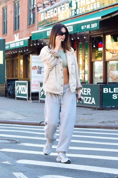 Emily Ratajkowski bared her abs with low-slung gray sweatpants that she wore with the top rolled down in New York City on May 31. She paired the Y2K-inspired look with a light mint crop top and a cream oversized bomber jacket.