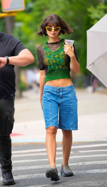 Emily Ratajkowski was photographed walking her dog Colombo in New York City while wearing a pair of baggy jean shorts.