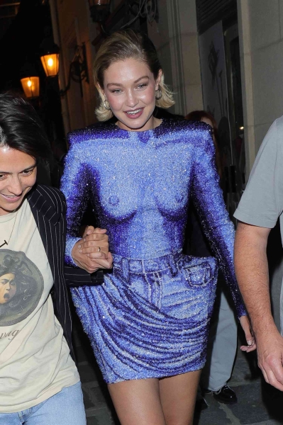 Gigi Hadid wore a Balmain minidress with faux nipples and a trompe l'oeil denim skirt detail to the after-party for Vogue World Paris. See her full look, here.