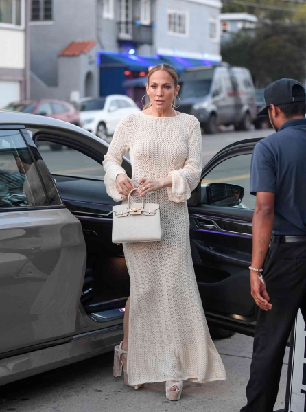Jennifer Lopez stepped out for dinner at Giorgio Baldi in a cream-colored crochet maxi dress. See her full look here.