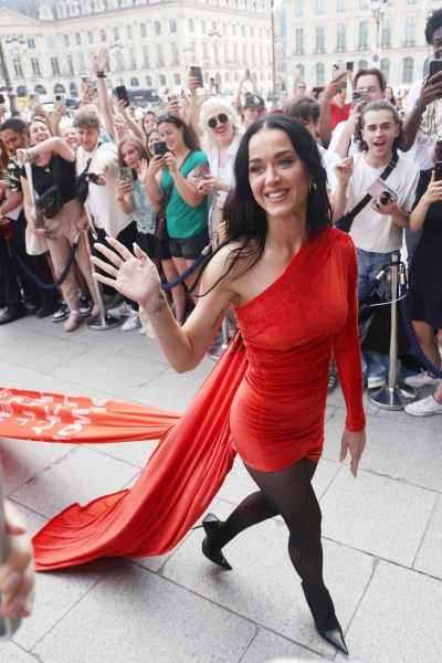 Katy Perry gave a nod to her upcoming single "Woman's World' by wearing a red minidress with the longest train inscribed with the lyrics. See the look, here.