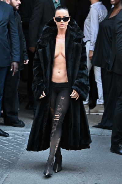 Katy Perry went shirtless and exposed her chest and midriff while attending the Balenciaga Haute Couture Fall/Winter 2024-2025 show for Paris Fashion Week.