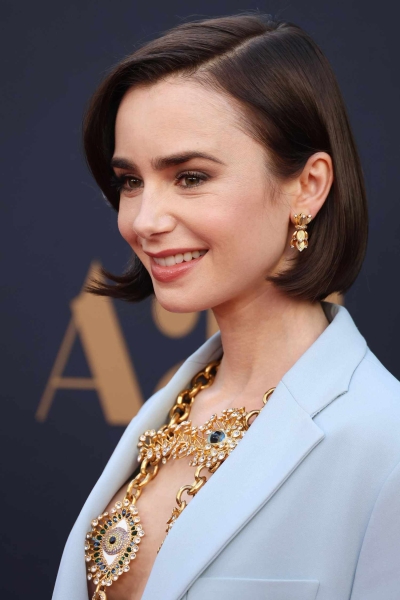 Lily Collins debuted a dramatic new bob and a darker hair color at the world premiere of 'MaXXXine' on June 24. See the summer hair transformation, which she cut herself.