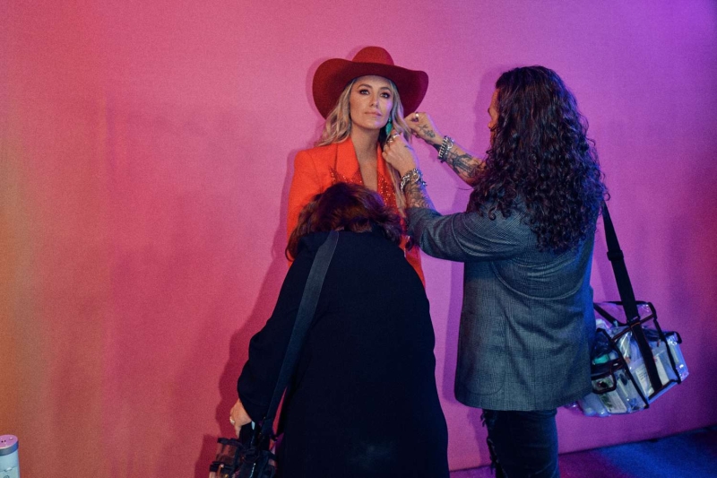 Lainey Wilson gave InStyle an exclusive look behind the scenes as she got ready for the 2024 ACM Awards, where she took home three awards. See her glam process, details on her chic Area suit, the story behind her Kendra Scott jewelry, and more.