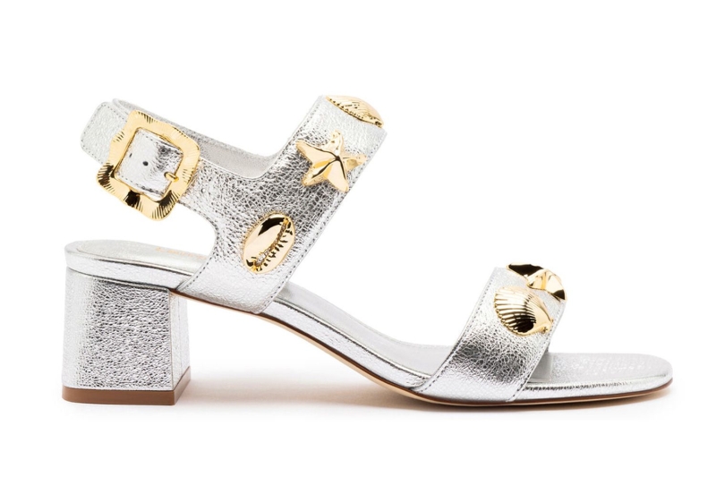 Look of the Day for July 8, 2024 features Kim Cattrall in a pair of silver and gold metallic sandals. Shop similar summer heels from Dolce Vita, Franco Sarto, and Larroudé.