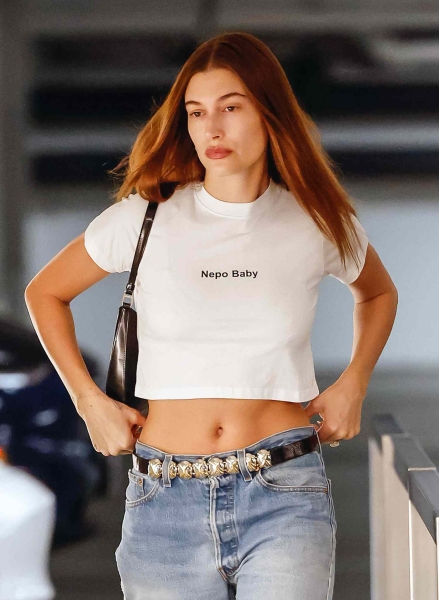 Why not stir the pot with a cheeky little message? From Rihanna to Drew Barrymore, the y2k slogan fashion trend is back and pettier than ever. Here's a look back at the most sly t-shirts from the 2000s through today and what they mean for the culture.