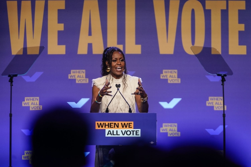 Michelle Obama spoke at a rally for her nonprofit When We All Vote in Georgia while wearing a super unexpected fall top with distressed jeans. See her look, here.