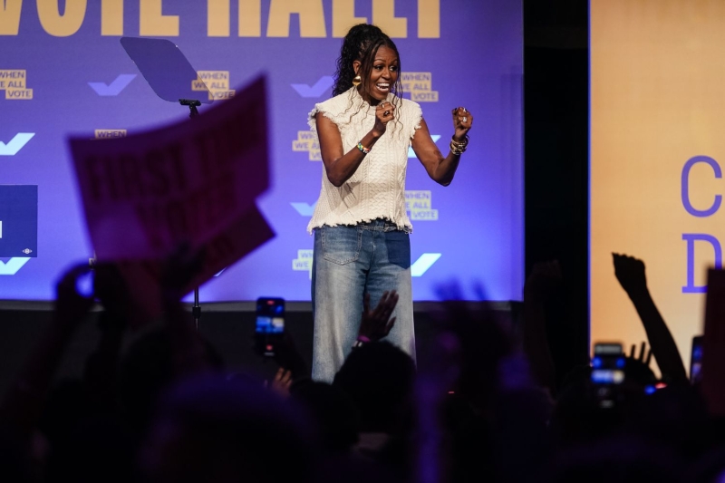 Michelle Obama spoke at a rally for her nonprofit When We All Vote in Georgia while wearing a super unexpected fall top with distressed jeans. See her look, here.