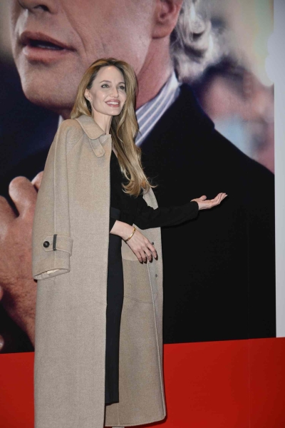 Angelina Jolie attended the 42nd annual Torino Film Festival on November 24 and wore a v-neck sweater, a high waisted midi skirt, and a controversial Y2K shoe—the ballet flat—all in black for her appearance on the red carpet for the event.