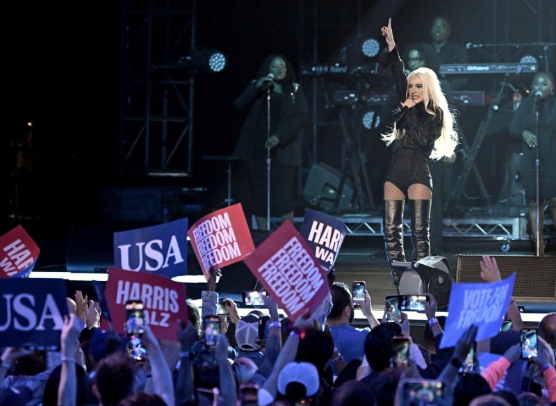 Christina Aguilera wore an outfit that consisted of gold high waisted underwear and thigh high boots to the reopening of H&M Times Square.