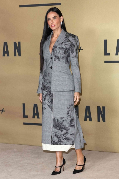 Demi Moore leaned into winter florals wearing a gray checkered skirt suit that went all the way to her ankles for the UK screening of 'Landman' on Friday, November 8 in London. Just hours earlier, the actress wore a caramel Gucci horsebit jacket paired with matching ballet flats and a pussy bow blouse.