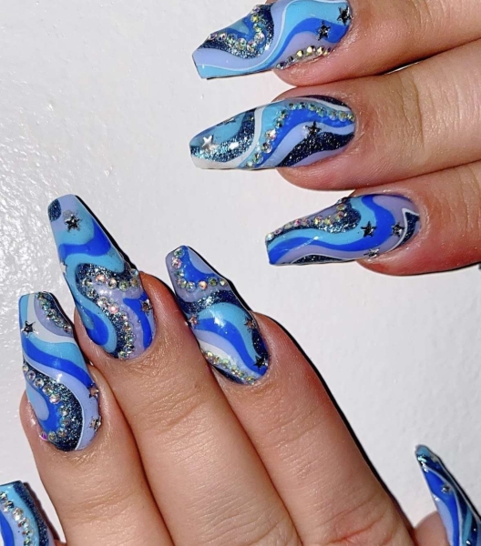 Embrace winter nail designs by incorporating elements like cool-toned colors and cable-knit textures. Scroll through 50 inspirational photos here.