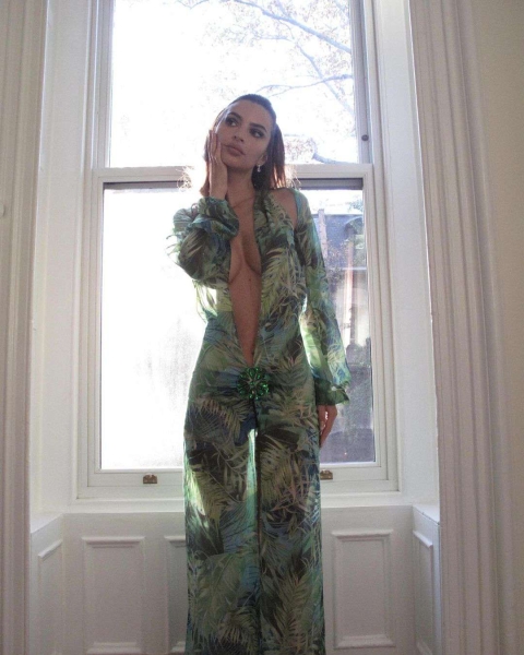 Emily Ratajkowski dressed up as Jennifer Lopez for Halloween and recreated her iconic green Versace dress moment. See her full costume, here.