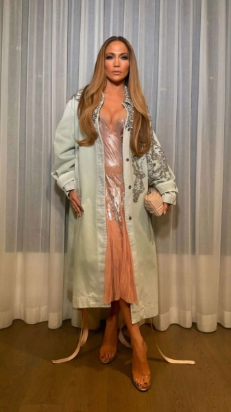 Jennifer Lopez took style cues from 'Wicked' as she stepped out in a iridescent blush pink slip dress for dinner with 16-year-old twins Emme and Max, just hours after making an appearance at the 2024 AFI Fest on Saturday, October 26,