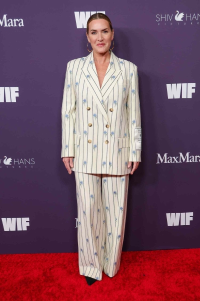 Kate Winslet stepped out at the Women In Film gala wearing a floral pinstripe suit with an unexpected message written on her sleeve.