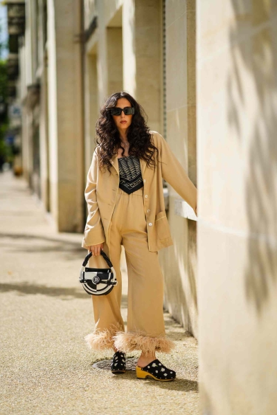 Satin pajama sets have become a street style staple and we've got 14 fresh ways to wear them. Here's how to wear a satin pajama set outside of the house for date night, brunch, and everything in between.