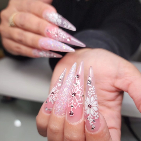 Snowflake nail art is a classic look that can be worn throughout fall and winter. Whether you want a detailed snowflake on each finger, or you want your nails to look flocked, snowy nails are all up to your personal interpretation. We share some of the best versions of the trend, here.