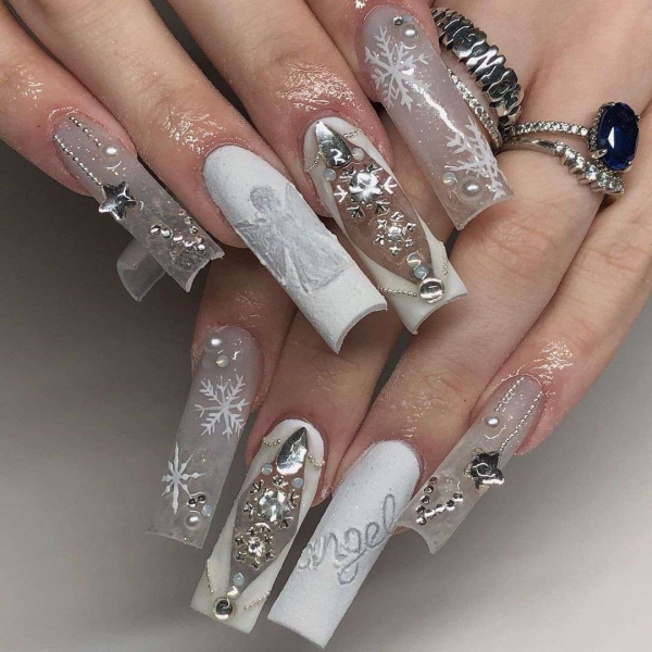 Snowflake nail art is a classic look that can be worn throughout fall and winter. Whether you want a detailed snowflake on each finger, or you want your nails to look flocked, snowy nails are all up to your personal interpretation. We share some of the best versions of the trend, here.