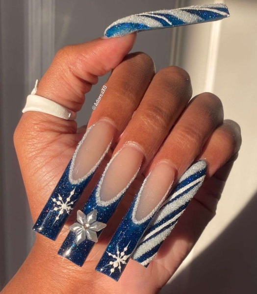 Snowflake nail art is a classic look that can be worn throughout fall and winter. Whether you want a detailed snowflake on each finger, or you want your nails to look flocked, snowy nails are all up to your personal interpretation. We share some of the best versions of the trend, here.