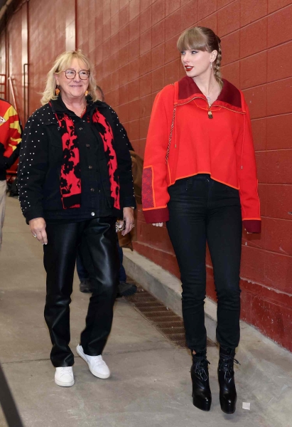 Taylor Swift arrives at boyfriend Travis Kelce's football game on Friday, November 29. She wore black skinny jeans tucked into her ankle boots and a red Louis Vuitton quarter-zip sweater.