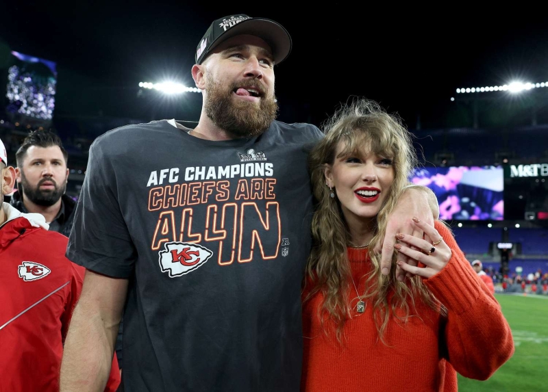 Taylor Swift arrives at boyfriend Travis Kelce's football game on Friday, November 29. She wore black skinny jeans tucked into her ankle boots and a red Louis Vuitton quarter-zip sweater.