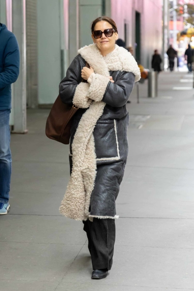 Katie Holmes wore a cozy shearling winter coat that was reminiscent of Penny Lane's coat from 'Almost Famous.' See her outfit, here.