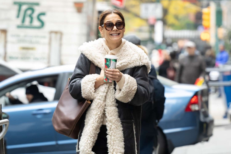 Katie Holmes wore a cozy shearling winter coat that was reminiscent of Penny Lane's coat from 'Almost Famous.' See her outfit, here.