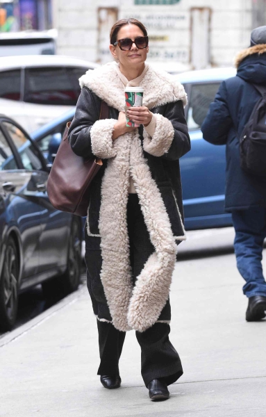 Katie Holmes wore a cozy shearling winter coat that was reminiscent of Penny Lane's coat from 'Almost Famous.' See her outfit, here.