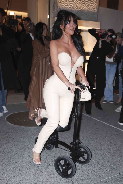 Kim Kardashian wheeled up to the SKIMs flagship store opening in Midtown Manhattan while debuting a brand-new accessory—a knee scooter—and a fresh set of bangs. See her full look, here.