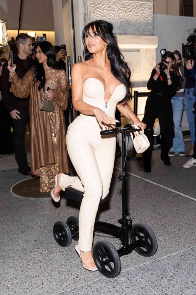 Kim Kardashian wheeled up to the SKIMs flagship store opening in Midtown Manhattan while debuting a brand-new accessory—a knee scooter—and a fresh set of bangs. See her full look, here.