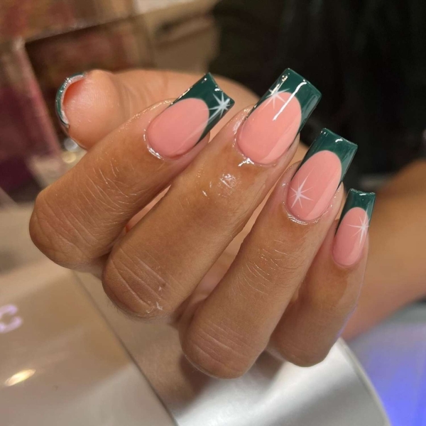 Looking for a little end-of-year mani inspo? Here, manicurists reveal their favorite December nail ideas. Along with the expected holly-jolly palettes, the nail artists we spoke with forecast bows, silver and gold accents, elevated French tips, and frosty chrome finishes to reign supreme this holiday season.