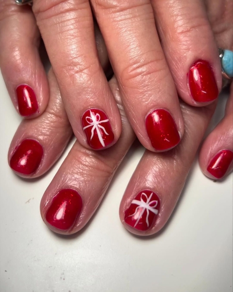 The color red is synonymous with Christmas and warm holiday cheer. Here, scroll through 18 red Christmas nail ideas for a festive touch this season.