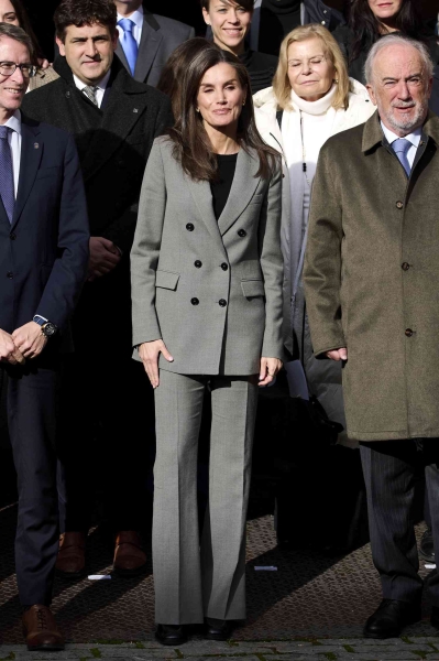 The Spanish royal stepped out in a gray pantsuit that she also wore back in October. See photos of the elegant menswear look, here.