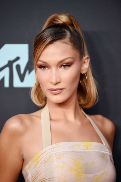 We love Bella Hadid's signature chocolate-brown hair color, her sleek slickbacks with not a single hair out of place, and her ability to pull off any style of bangs, from blunt and rounded to long and piece-y. Explore a gallery of her best looks.