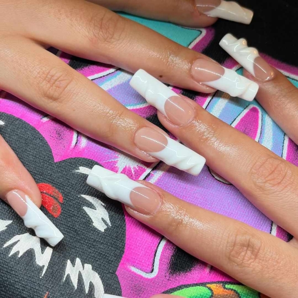 Whether you go for a classic French manicure, a milky-white base, or pop on a glittery top coat, you'll be left with a look that's festive for the season in an understated way. Browse through 20 stunning winter white nail ideas and screenshot your faves for your next manicure.