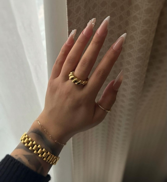 Whether you go for a classic French manicure, a milky-white base, or pop on a glittery top coat, you'll be left with a look that's festive for the season in an understated way. Browse through 20 stunning winter white nail ideas and screenshot your faves for your next manicure.