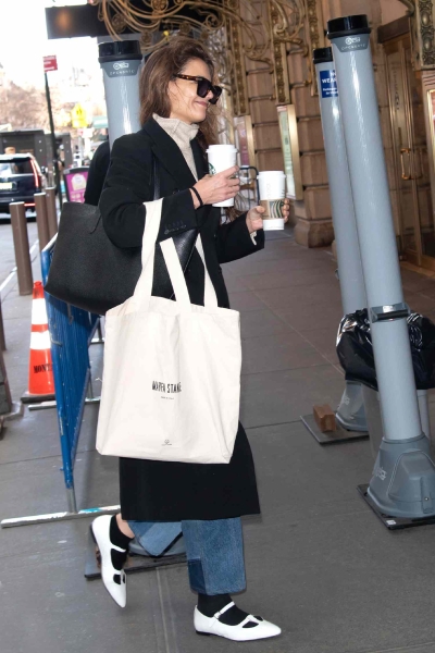 Katie Holmes was spotted out in New York City wearing a pair of white ballet flats with black ankle-length socks. See her quirky footwear combination, here.