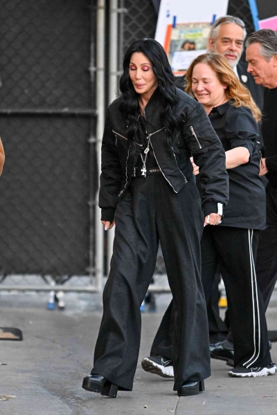 Look of the Day for January 8, 2025 features Cher in an all-black outfit that includes wide-leg trousers, a black shirt, leather moto jacket, and chunky black leather boots. Shop her winter-perfect ensemble from Naturalizer, Steve Madden, and more.