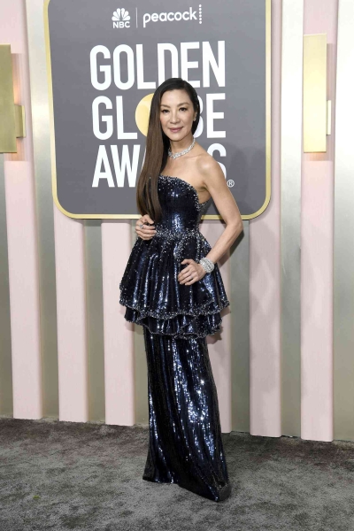 Michelle Yeoh presented at the 2025 Golden Globe Awards and wore a gown by Balenciaga and a fresh set of bangs. See Yeoh's 2025 Golden Globes red carpet and presenting outfits here.