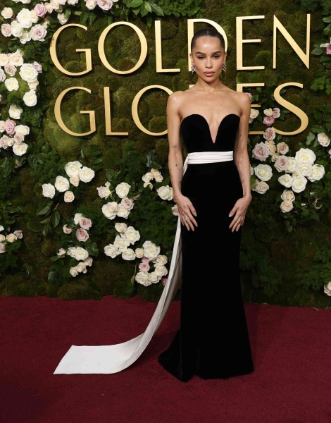 Zoë Kravitz attended the 2025 Golden Globes wearing a custom Saint Laurent gown by Anthony Vaccarello. It features a plunging sweetheart neckline and a cascading sash. See her full look, here.